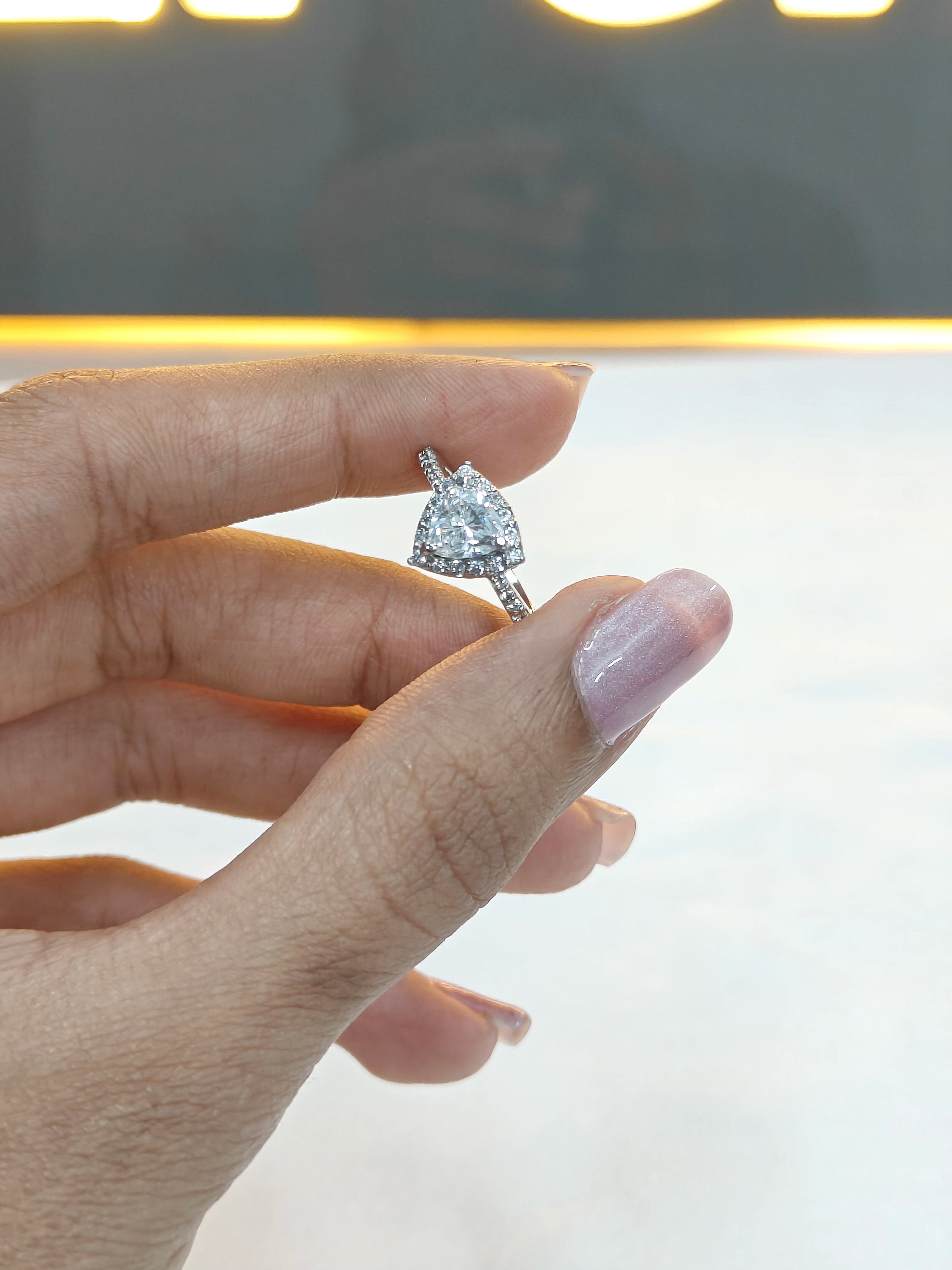 Diamond ring on a finger with a blurred background